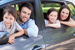 Happy family sitting in the car