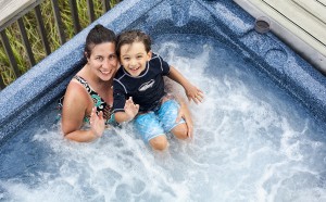 Woman and child in jacuzzi waving to camera