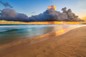 Seascape with dark rain clouds at sunset