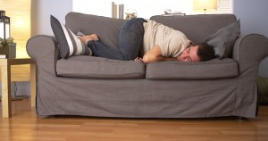 Man trying to sleep on couch