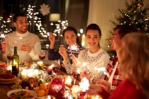 happy friends celebrating christmas at home feast